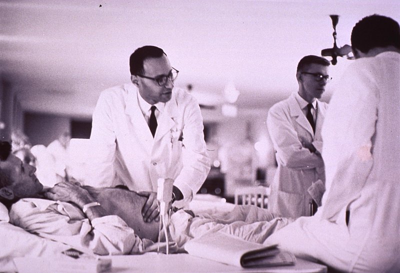 Clinical - healthcare professional using tablet at bedside
